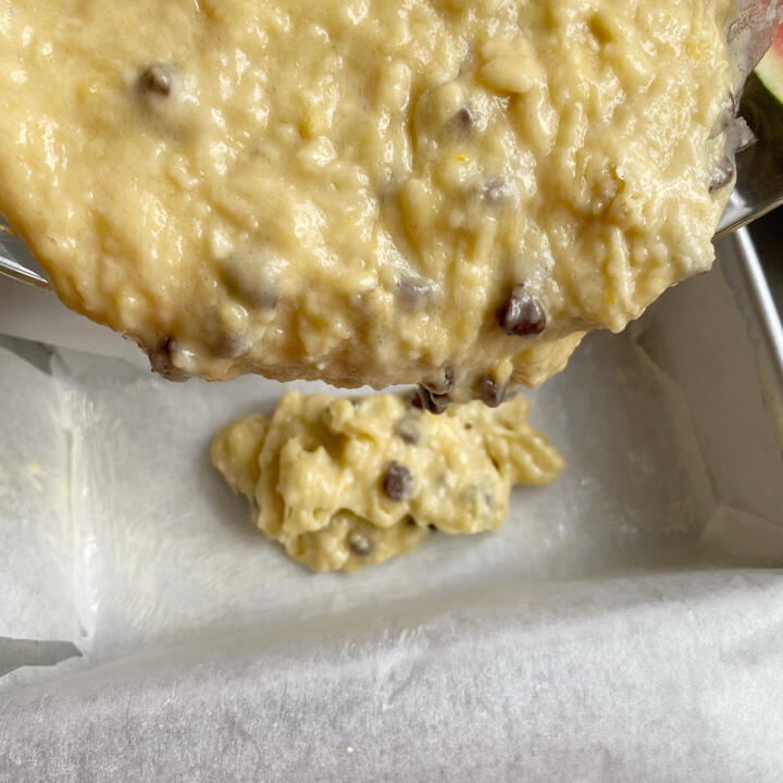 pouring batter into baking tray for chocolate chip banana bread