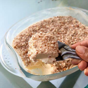 image for eggless butter pudding recipe, held up by a spoon